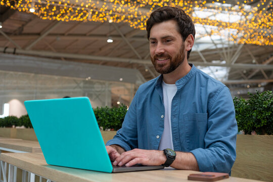 an inspired man at his laptop