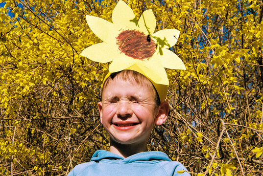 Film portrait of boy with yellow flowers in spring
