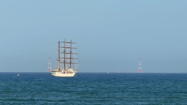 Vietnam, Nha Trang 26.08.2026 - A white sailboat sailing across the blue sea. A real frigate ship, large masts and sailors on board, a tourist ship with sails