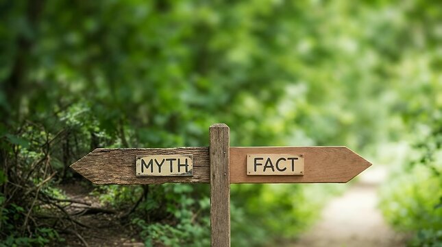 A myth versus fact visualization showing wooden signpost with two opposite arrows over green leaves background with Myth versus Fact directional signs for choice concept for leadership and decision