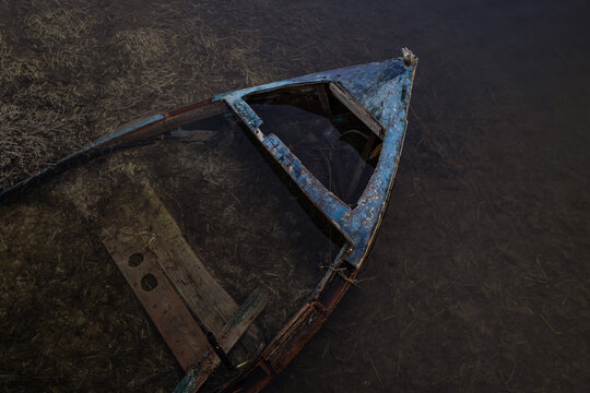 Old Abandoned Wooden Boat Submerged in Shallow Water