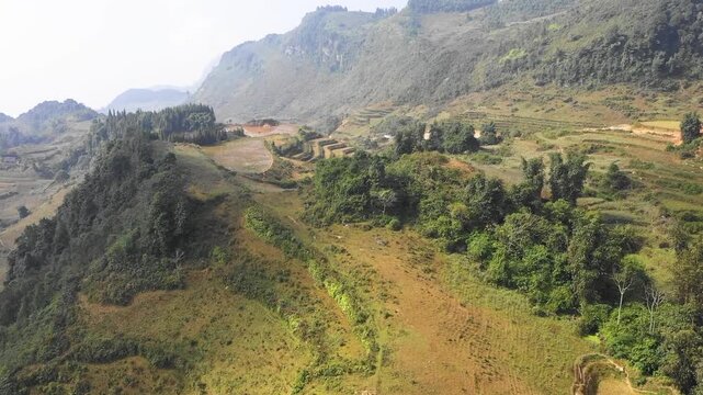 Drone footage of the mountainous region near Bac Ha in Lao Cai province, northern Vietnam. The landscape is marked by traditional agriculture and dramatic mountain terrain, typical of the region.