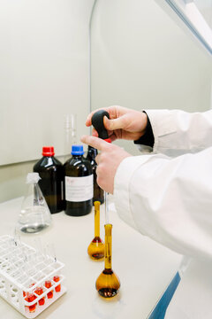 A scientist takes liquid measurements in a chemical laboratory.