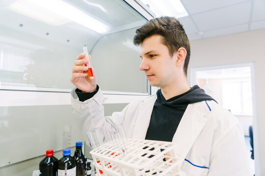 A man holds test tubes in a laboratory.