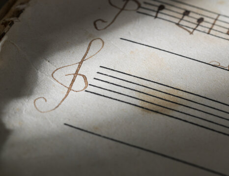Handwritten Treble Clef on Vintage Music Sheet