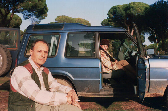 Man and passenger resting next to off road vehicle