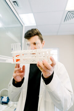 A man holds test tubes in a laboratory.