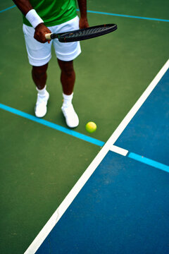 Tennis player preparing to serve on court