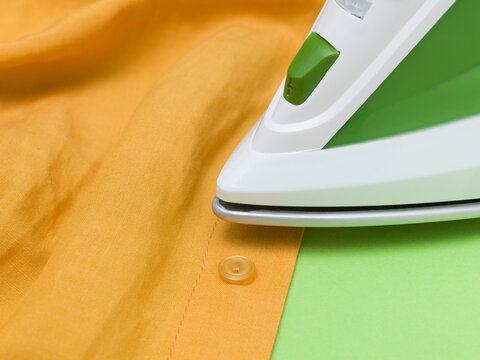Green Steam Iron Pressing Yellow Cotton Shirt