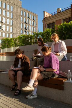 Students studying together on urban rooftop terrace