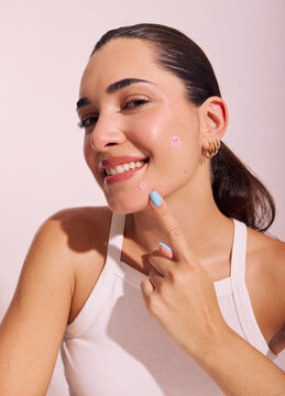Woman Shows off Skincare Stickers on Her Face in a Light Setting