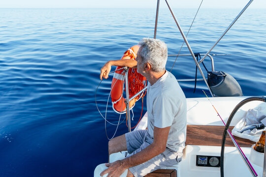 Senior man sailing at sea feeling freedom