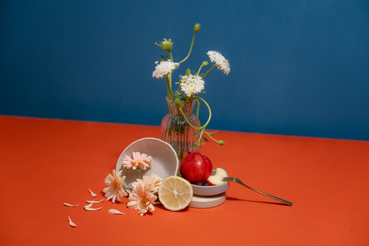 Delicate floral arrangement with fresh fruit and a golden fork