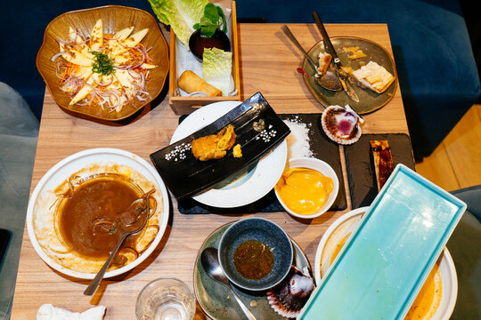 Dining table full of food leftovers after meal