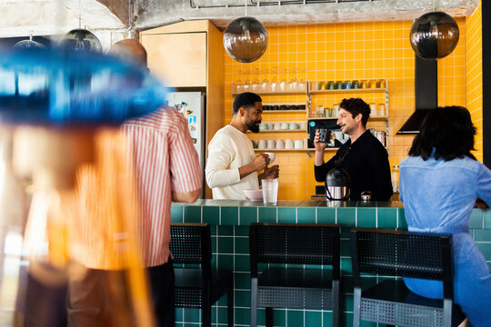 Friends Chatting Over Coffee At Work