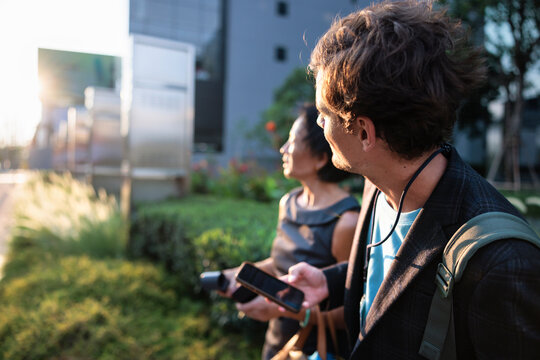 A man and woman standing outdoors during the golden hour