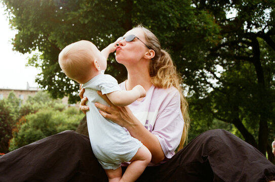Mother and baby share a joyful moment in park