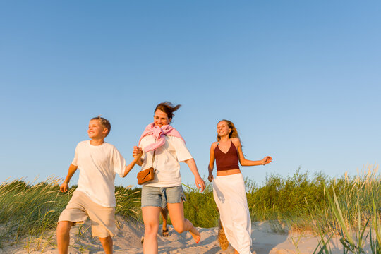 Mother and Two Kids Having Fun in the Beach