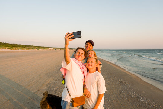 Family Take a Selfie During Vacation On The Sea