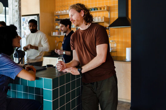 Friends Chatting at Kitchen Bar Counter 