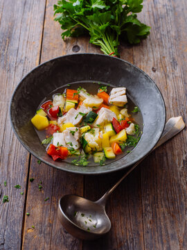 Fish soup with vegetables in a bowl