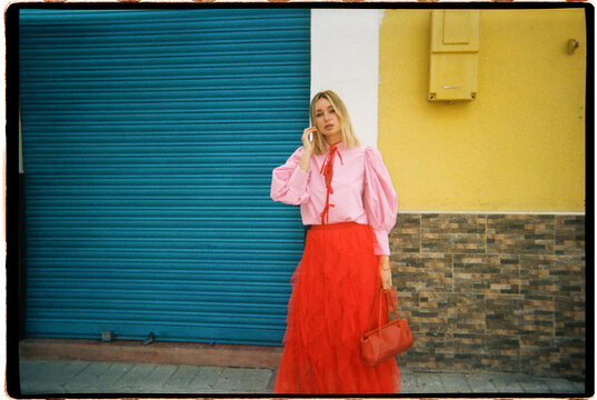 Woman posing in vibrant outfit outdoors