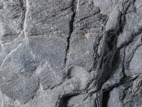 Macro Close-Up of Rugged Grey Stone with Mineral Veins and Cracks