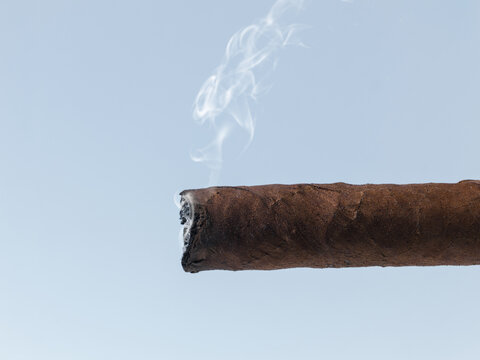 Lit Cuban Cigar with Wispy Smoke Close Up