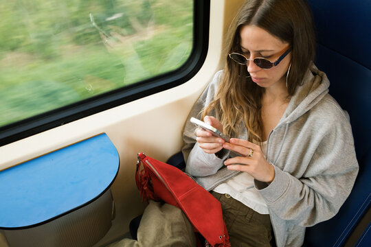 Woman enjoys her time on a train with a view