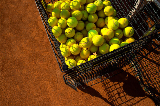 Above view of many tennis balls in the cart.
