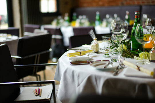 Dinner setup in a restaurant with elegant table arrangements