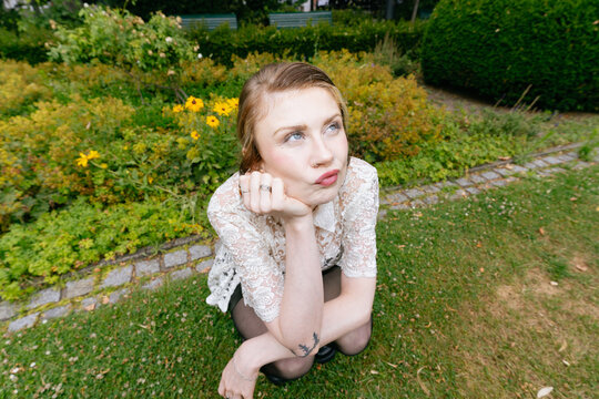 Young Woman Sitting in Garden