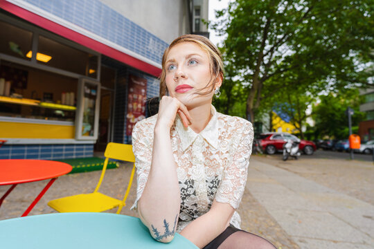 Pensive Woman at Outdoor Cafe
