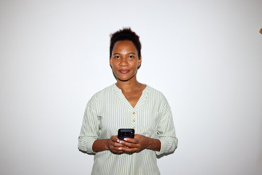 Woman smiles against neutral background