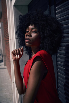 Confident woman poses on city street during daytime