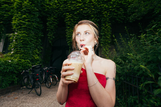 Woman Drinking Iced Coffee Outdoors