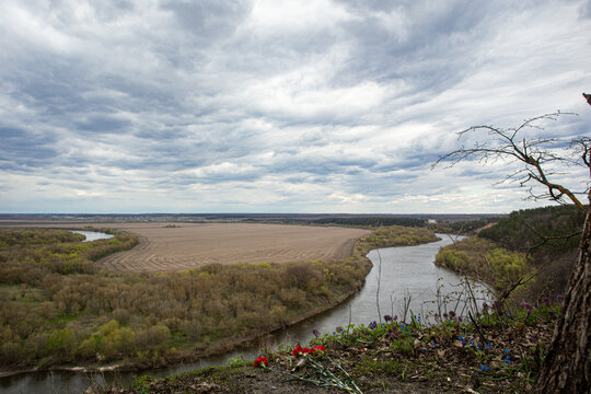 VORONEZH, Russia - April 25, 2026.View from the rim of Krivoborye natural monument showing memorial carnations and the Don River plain in spring