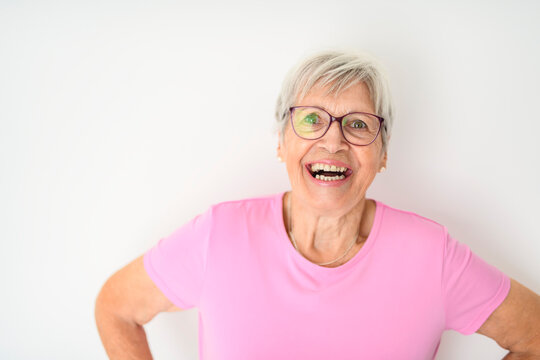 Portrait of elderly woman with eyeglasses over studio white