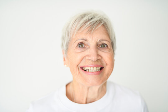 Portrait of elderly woman with eyeglasses over studio white
