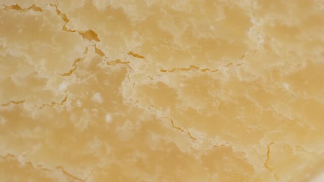 Cheese parmesan texture macro, rotation