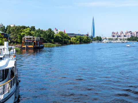 Saint Petersburg, Russia - July 31, 2026: view of Srednyaya Nevka river with Chayka restaurant on Martynov Embankment and Lakhta Center skyscraper in Saint Petersburg city, Russia on sunny summer day