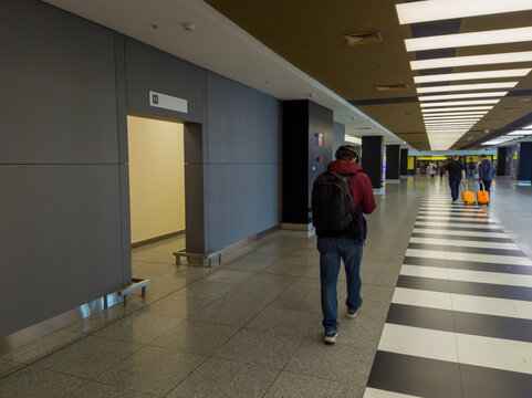 Man walking in airport terminal with luggage