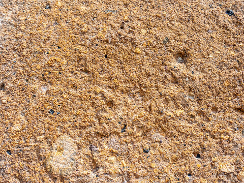 surface of orange tuff stone wall of church