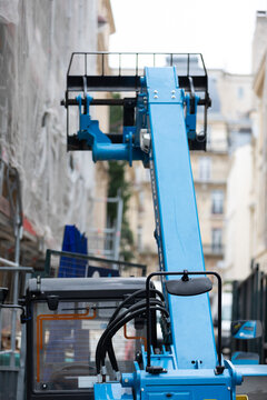 Blue Telescopic Handler at an Urban Building Renovation Site