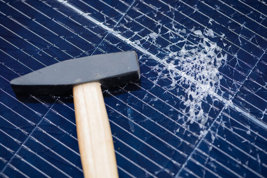 Hammer on Smashed Solar Panel with Shattered Glass