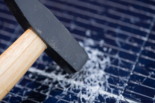 Hammer on Smashed Solar Panel with Shattered Glass