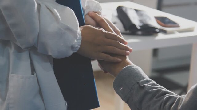 Woman, doctor and holding hands with patient for consultation, sympathy or comfort at hospital. Closeup, female person or medical professional with touch for grief, news or empathy at clinic visit