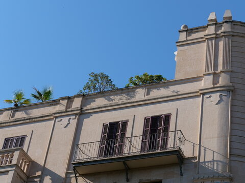 Rooftop Terrace with Palm Trees on Historic Mediterranean Building