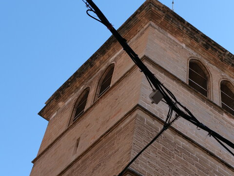 Historic Stone Bell Tower against Clear Blue Sky