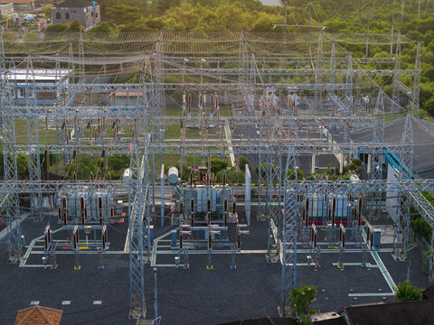 Aerial view of Nusa Dua Substation with electrical transformers, steel structures, and power lines in Kecamatan Kuta Selatan, Bali, Indonesia.